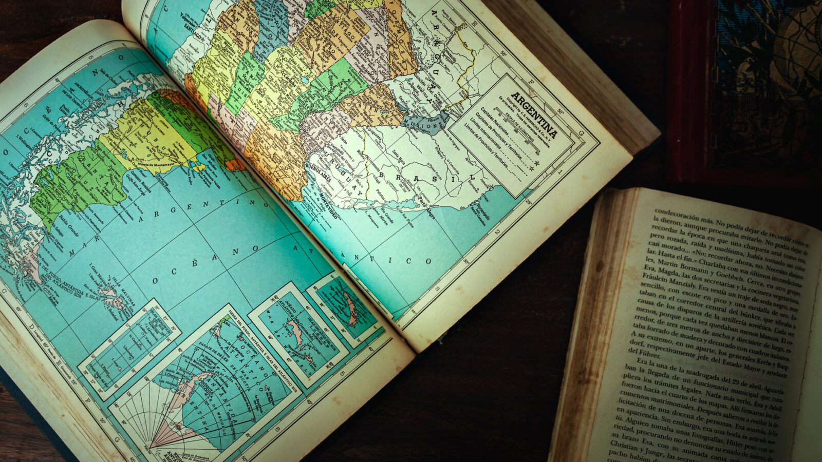 Explore an antique map of Argentina and vintage books on a wooden table.