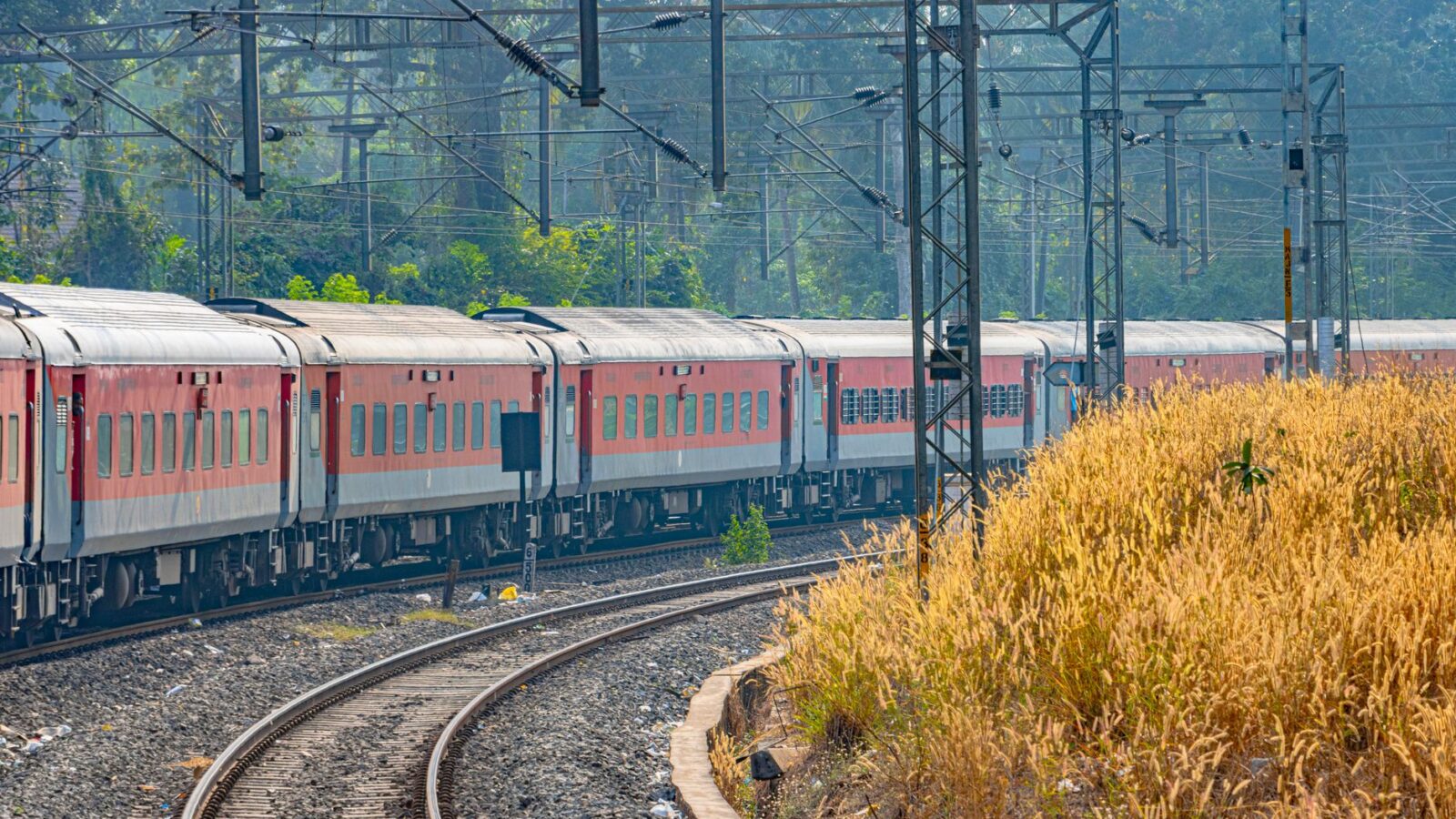 Scenic view of an Indian Railways passenger train passing through Karnataka, India.